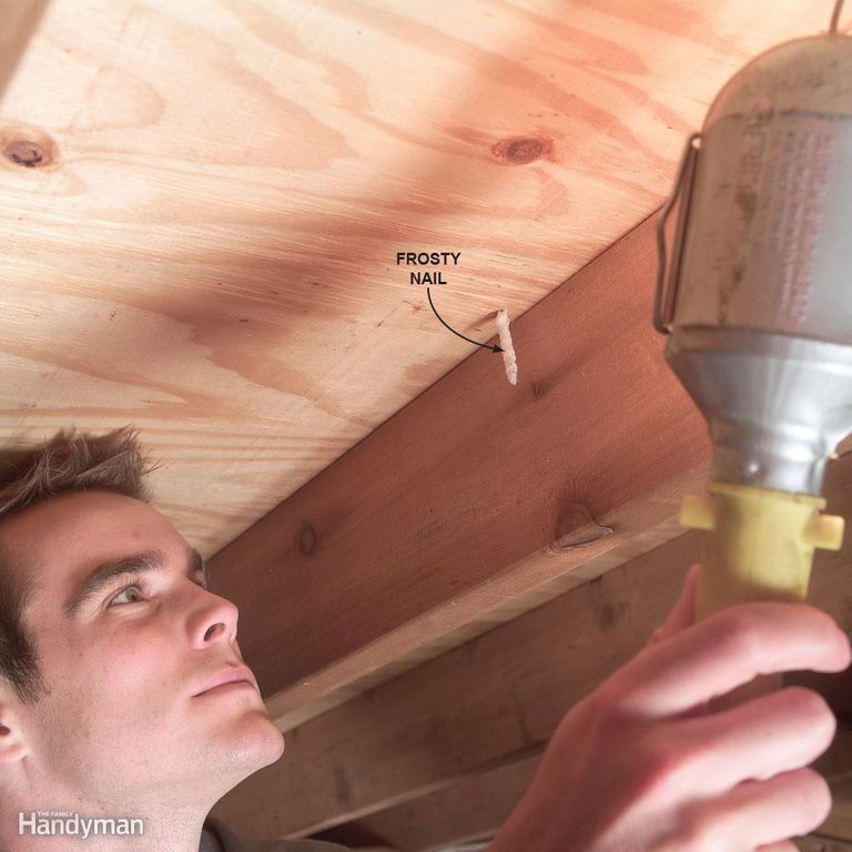 A man holding up an electrical device in his hand.