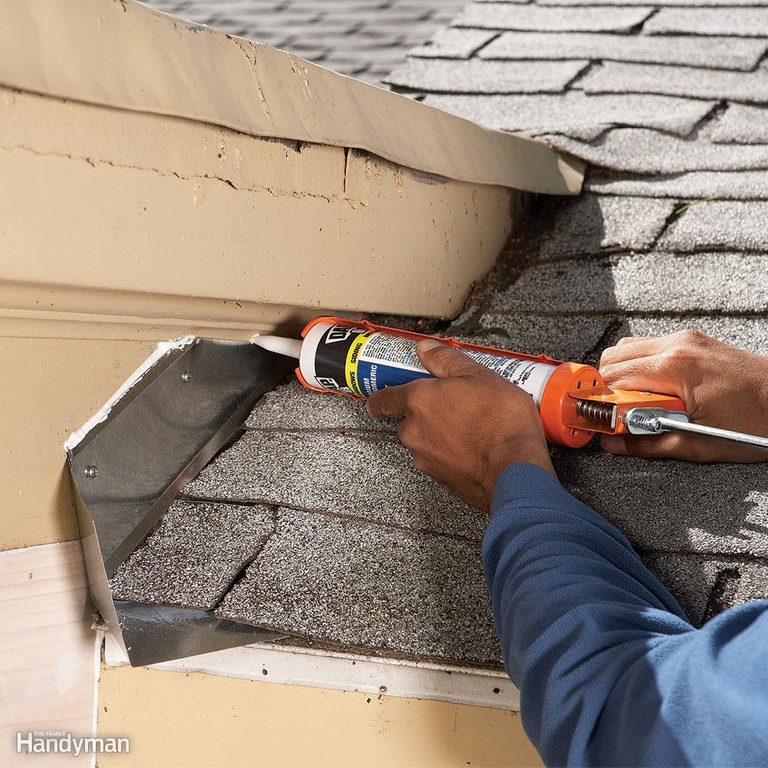 A person is using caulking to fix the roof of their house.