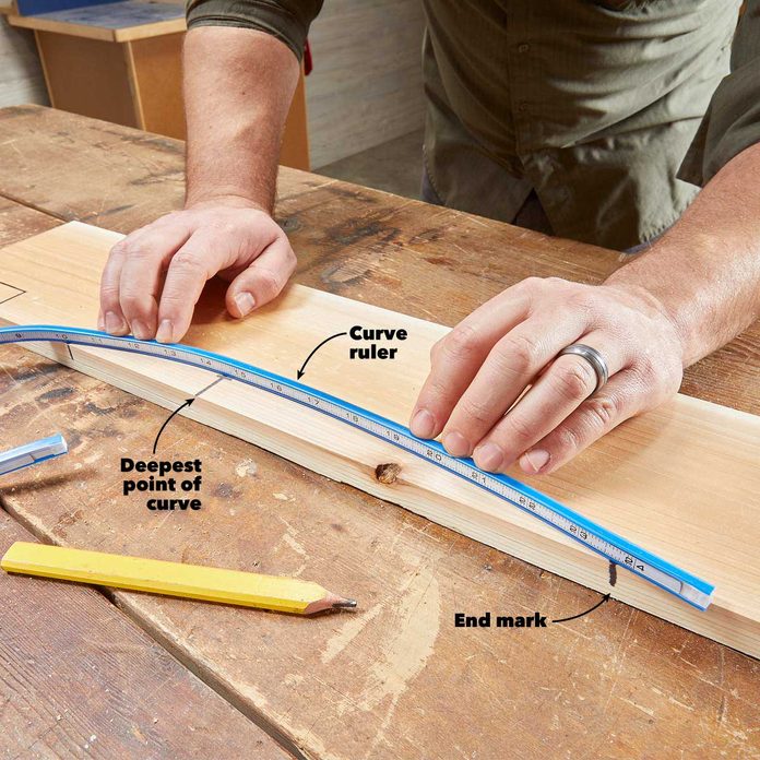 A person is measuring the length of a board.