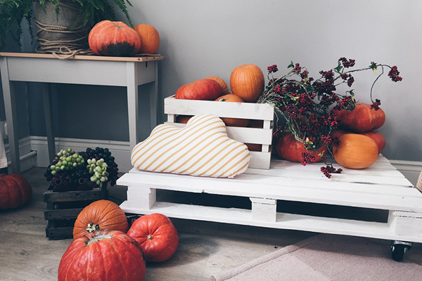 A white bench with pumpkins on it