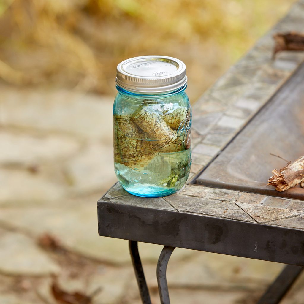 A jar of pickles sitting on top of a table.