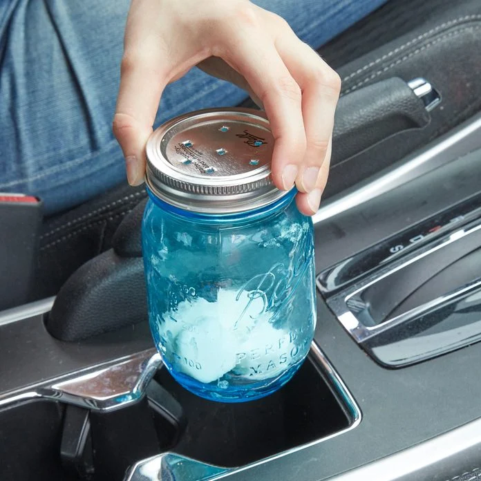 A person is holding onto a mason jar