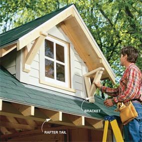 A man painting the roof of a house.