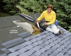 A woman sitting on the roof of her house