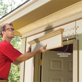 A man is standing outside of a house