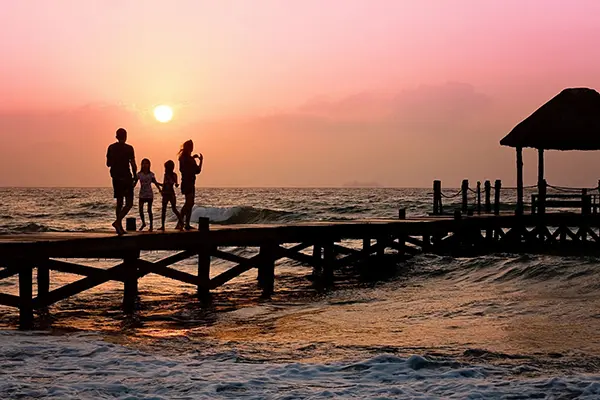 A group of people standing on the end of a pier.